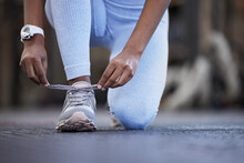 Make Sure Theyre Secure Before You Begin. Closeup Shot Of An Unrecognisable Woman Tying Her Laces In A Gym.