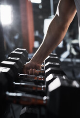 Canvas Print - Lets grab a heavier weight. Cropped shot of an unrecognizable male athlete grabbing a set of dumbbells during his workout in the gym.