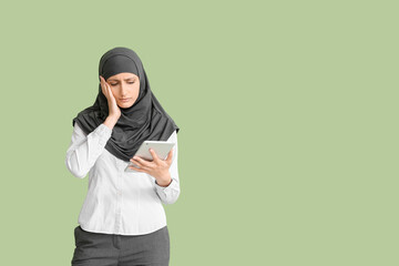 Sticker - Sad Muslim secretary with tablet on color background