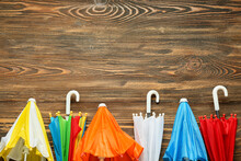 Many Different Umbrellas On Wooden Background, Closeup