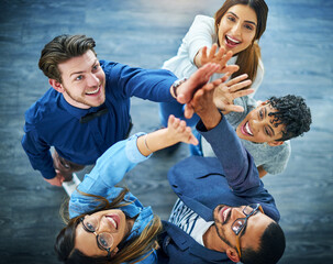 Poster - Cheers to the team-spirit. High angle shot of a group of .young businesspeople cheering in a modern office.