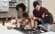 © Allistair/peopleimages.com - How does it taste Dad. Shot of a family of four cooking together in their kitchen at home.