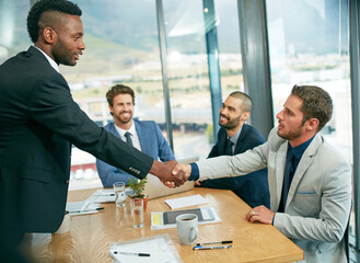Poster - Lets make it happen. Shot of businessmen shaking hands during a meeting.