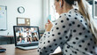 © Alex from the Rock - Woman has video call conference with her remote team. Laptop with camera teamwork