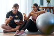 © Nicholas Felix/peopleimages.com - After workout snacks. Full length shot of an athletic young couple enjoying some healthy snacks after their workout at home.
