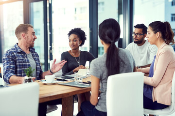 Wall Mural - discussing design. cropped shot of a group of colleagues working in their office.