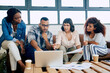 © Katleho Seisa/peopleimages.com - Lets talk tech. Shot of a group of colleagues using a laptop together in a modern office.