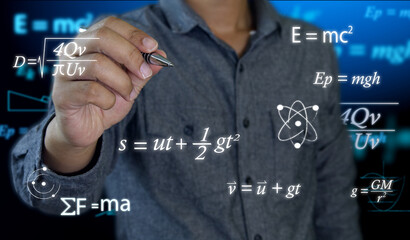 Wall Mural - a math or physics teacher holds a pen in his hand to write complex mathematical equations on a black