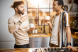 © rh2010 - Two guys of different ethnicity having warm conversation while drinking coffee on kitchen at home. Concept of close male friendship or relationship as gay couple. Caucasian and hispanic man together