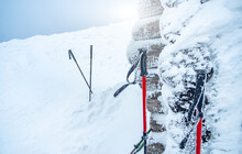 Trekking Sticks Standing In Deep Snow Near Tourist Shelter