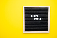 No panic test on a felt board on a yellow background.