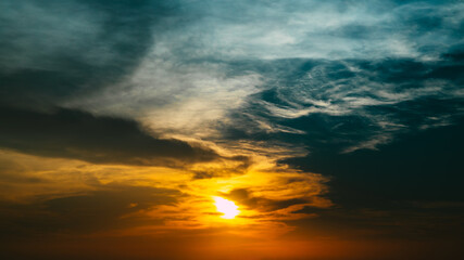 Wall Mural - sunset or evening time with dramatic sky with clouds and tree. in dark blue orange tone.
