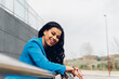 © Dani D.G - Cheerful black woman leaning on railing