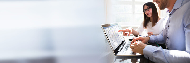 Two Businesspeople Analyzing Gantt Chart