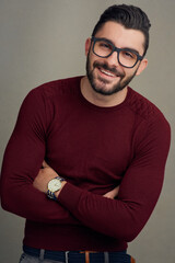 Canvas Print - Nobody ever needs a reason to smile. Studio portrait of a handsome young man posing against a grey background.