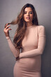 © Tamani Chithambo/peopleimages.com - Brunettes do it better. Portrait of a beautiful young woman posing against a grey background in the studio.