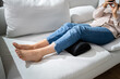 Woman Using Footrest To Reduce Back Strain