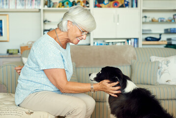 Poster - Obedience is key to a good relationship. Shot of a happy senior woman bonding with her dog at home.