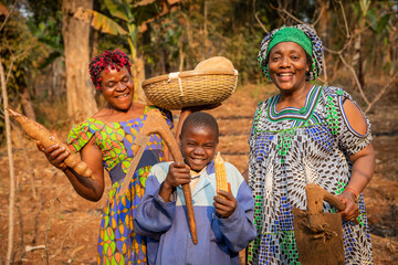 group of african farmers have fun in the fields, they have hoes in their hands and are ready to plow