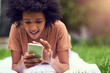© Ruan J/peopleimages.com - I never saw anything like this app. Shot of a young man texting while relaxing at the park.