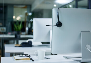 Solving problems one call at a time. Shot of a work station in a call centre.