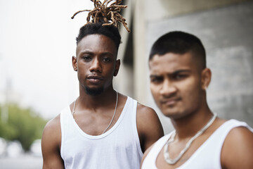 a gang is more than a family. cropped portrait of two handsome young male gangsters standing outside