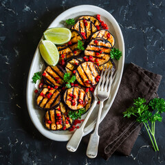 Wall Mural - Teriyaki sauce spicy grilled aubergine - a delicious snack, tapas on a dark background