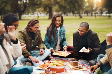Aufkleber - I dont know where to start. Shot of a group of cheerful young friends having a picnic together outside in a park during the day.