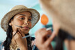 © Nicholas Felix/peopleimages.com - Putting on my best scary face. Shot of a young woman applying halloween makeup at home.