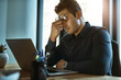 © Jadon Bester/peopleimages.com - When the stress of work triggers severe migraines. Shot of a young businessman looking stressed out while working on a laptop in an office.