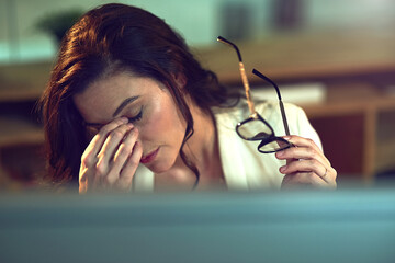 Canvas Print - This day has been too long. Cropped shot of a stressed out businesswoman working late in an office.