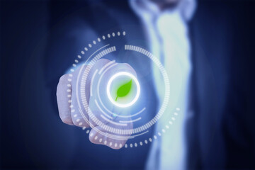 Man in suit, finger presses virtual green leaf button. Green technology concept