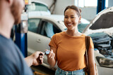 Fototapeta  - We take care of cars and the people who drive them. Shot of a woman receiving her car keys.