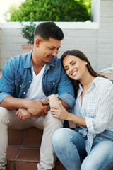 Wall Mural - True love. Cropped shot of an affectionate young couple sitting outside on their patio in the yard.