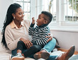 © Wayde Oostendorp/peopleimages.com - Just like that.... Shot of a little boy using his inhaler while sitting at home with his mother.