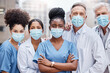 © Nicholas Felix/peopleimages.com - This pandemic wont get them down. Shot of a group of doctors standing in the city.