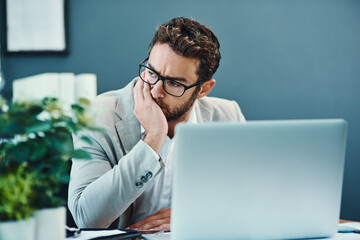 Aufkleber - How did this day turn into such a big stress. Shot of a young businessman looking stressed out while working on a laptop in an office.