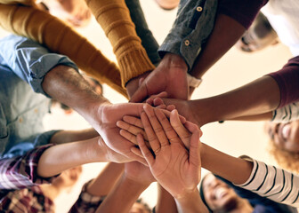 Sticker - Joining their strengths in unity. Low angle shot of a group of people joining their hands together.