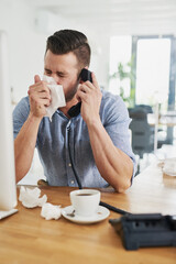 Aufkleber - The cold has left him feeling quite congested. Cropped shot of a young businessman blowing his nose while speaking on the phone in an office.