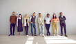 © Studio Romantic - Portrait of diverse multiethnic businesspeople pose near grey wall background show unity and leadership. Multicultural employees or colleagues demonstrate diversity at workplace. Teamwork concept.
