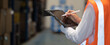 © Shutter B - Panoramic close up hand of smart engineer man warehouse management system.Worker hands holding tablet with pen on blurred warehouse as background. logistic, Import export concept.
