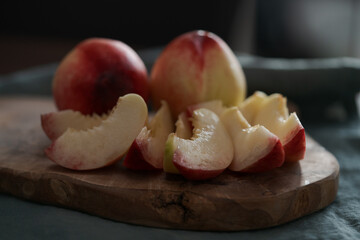 Wall Mural - ripe nectarines on wood board with natural lighting