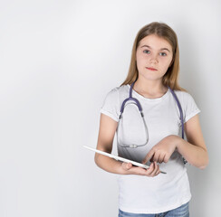 Wall Mural - a  girl doctor  with a stethoscope and tablet.  white background. health check concept