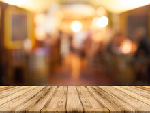 Wooden Board Empty Table Top On Of Blurred Background. Perspective Brown Wood Table Over Blur In Coffee Shop Background - Can Be Used Mock Up For Montage Products Display Or Design Key Visual Layout.