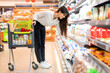 © Prostock-studio - Middle Eastern Lady Shopping Groceries Choosing Dairy Product In Supermarket