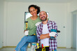 © NVB Stocker - Portrait Cheerful couple young man and black woman smiling during renovation in new apartment