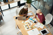 © Chanelle Malambo/peopleimages.com - We work so well together. High angle shot of two attractive young businesswomen sitting together and working with technology and paperwork during a strategy meeting.