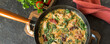 pan with chicken breast with spinach and tomatoes in a creamy sauce on the table