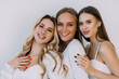 © F8  \ Suport Ukraine - three beautiful women of appearance hug and smile on a white background.