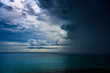 © Tetra Images - Dark thunderstorm clouds with rain over ocean